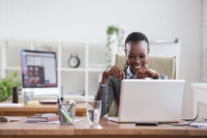 woman working at laptop | african american woman business women working on laptop | mycrecloud